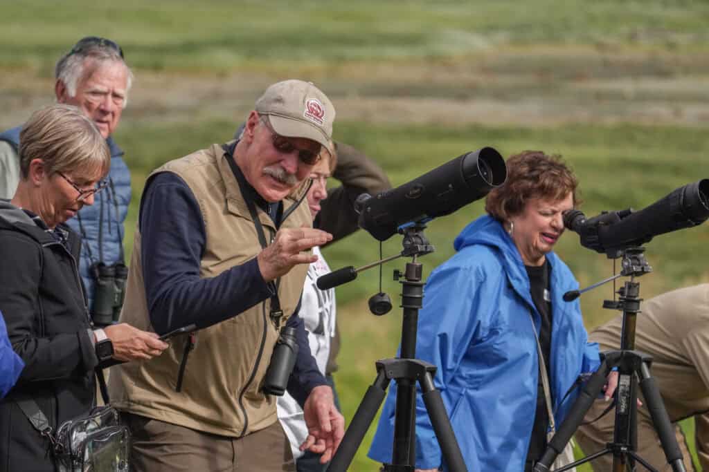 People gazing through telescopes.
